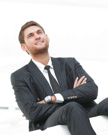 portrait of smiling businessman sitting on chairの写真素材