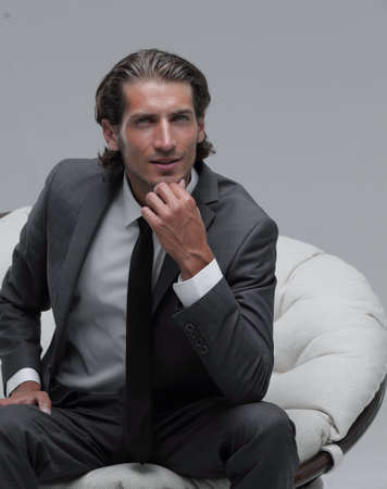 confident businessman sitting in chair