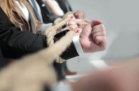 Hands of businessmen, twisted by a ropeの写真素材