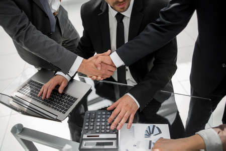 Handshake across the table of financial partnersの写真素材