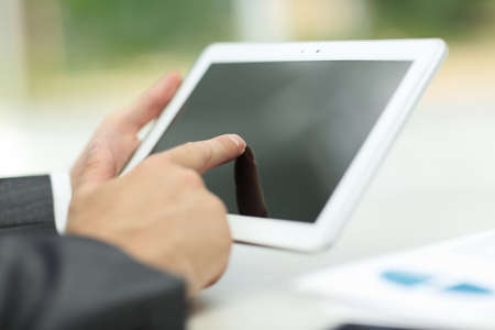 closeup.successful businessman working with tablet computer