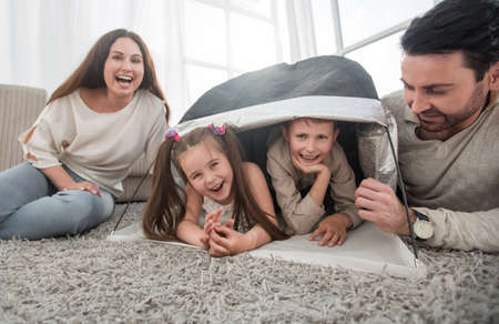 happy family having fun in a new apartmentの写真素材