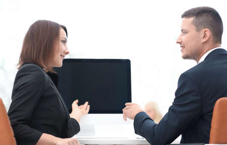 business associates talking at a Desk.