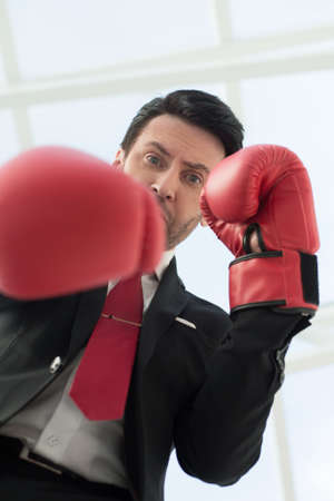 close up.a serious businessman in red Boxing glovesの写真素材