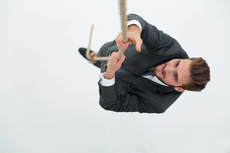 successful businessman climbing the ropeの写真素材