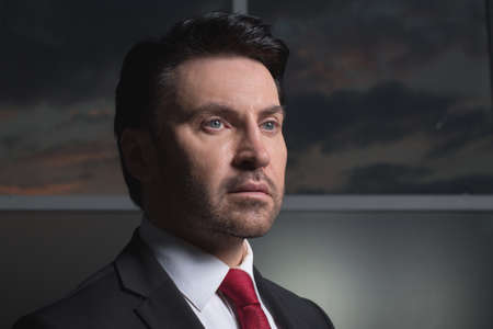 businessman standing near the office window