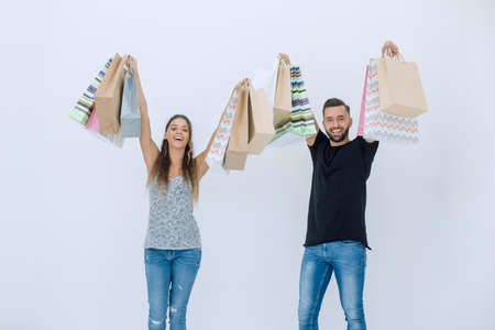 young couple holding shopping bags and looking at the cameraの写真素材