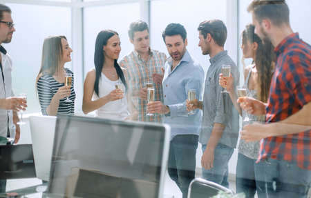 business team with wine glasses standing in the officeの写真素材
