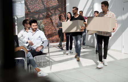 creative business team brings cardboard boxes to the new officeの写真素材