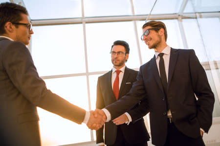 in the foreground is the handshake of business peopleの写真素材