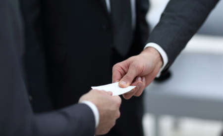 businessman handing business card to the partner.の写真素材