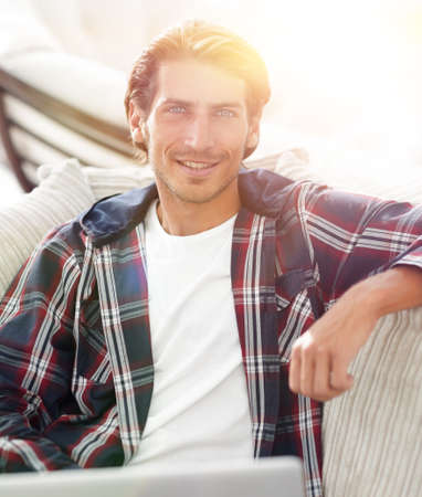 successful guy working on laptop and looking at camera. view from aboveの写真素材