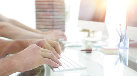 close-up of a workplace with a computer in a modern office.の写真素材