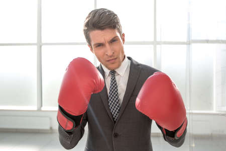 purposeful young businessman in Boxing gloves.の写真素材