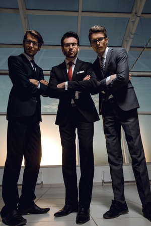 in full growth.three confident businessmen look forward