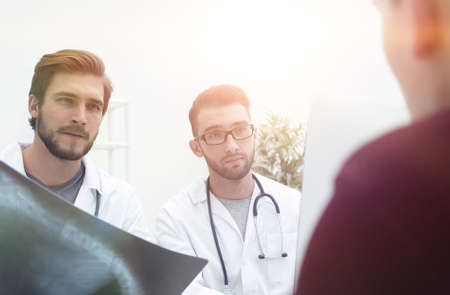 two doctors examining an x-ray of a patient