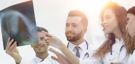 group of medical workers looking at patients x-ray film