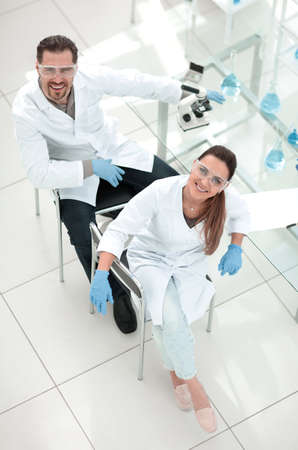 top view.two smiling lab assistants looking at the cameraの写真素材