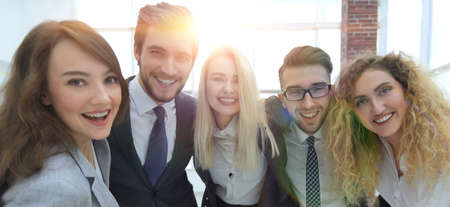 closeup.happy business team looking at camera