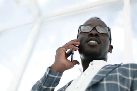 bottom view.smiling businessman talking on a mobile phone