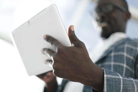 close up.successful businessman with digital tablet.photo with copy spaceの写真素材