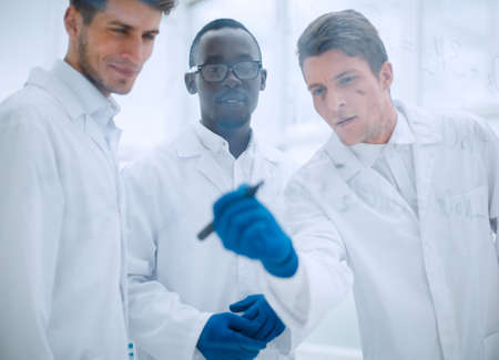 promising scientist makes notes on the Boardの写真素材