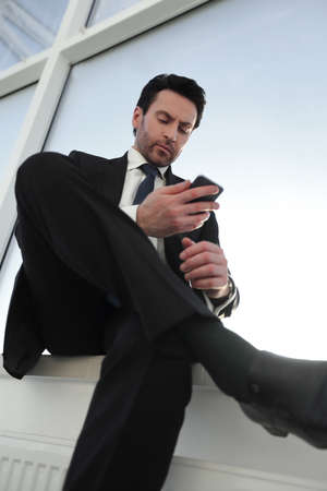 businessman typing SMS on his smartphone