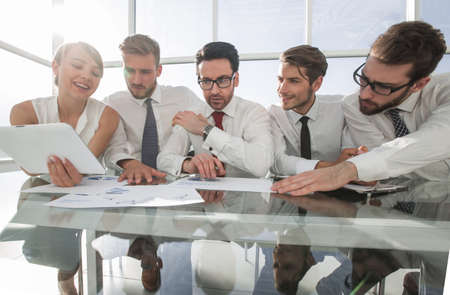 business team using a digital tablet to work with financial dataの写真素材