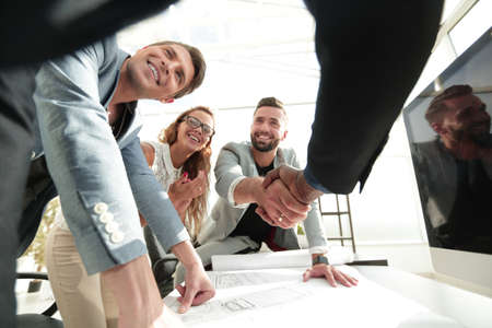 close up.businessman and architect shaking handsの写真素材