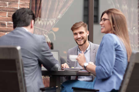 business colleagues discussing business issues at the coffee tableの写真素材