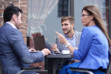 business colleagues discussing business issues at the coffee tableの写真素材