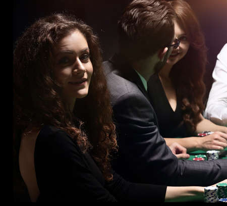players sitting at the playing table in the casinoの写真素材