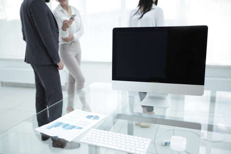 employees of the company talking near the desktop