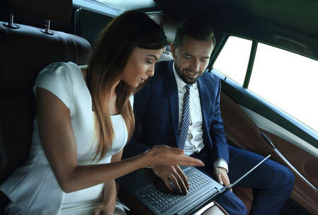 Conversation of two business people in driving car