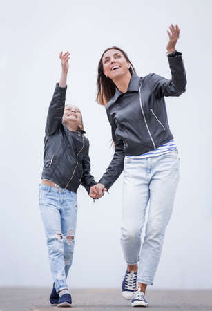 in full growth.happy mother and daughter walking togetheの写真素材