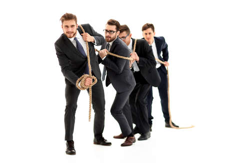 closeup.smiling business team pulls the rope.の写真素材