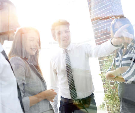 from behind the glass.business team in the officce