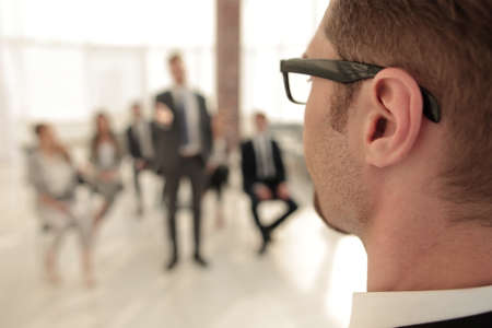 boss looks at the staff sitting in the conference roomの写真素材