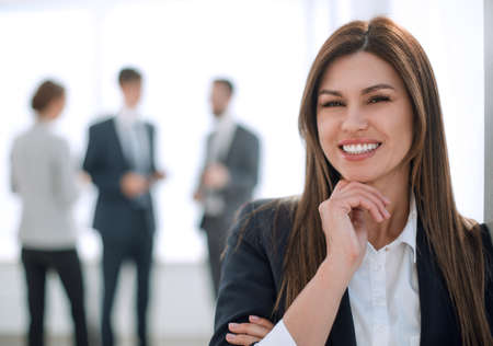 smiling business woman on blurred office background