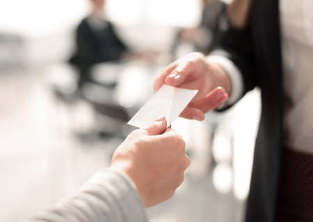 close up.two business woman exchanging business cardの写真素材