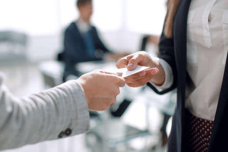 close up.two business woman exchanging business cardの写真素材