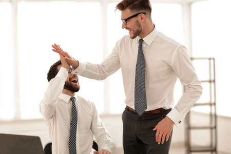 close up.two employees giving each other a high fiveの写真素材