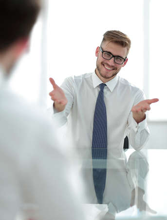 confident businessman sitting at the office table