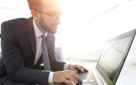 Concentrated professional IT developer with laptop