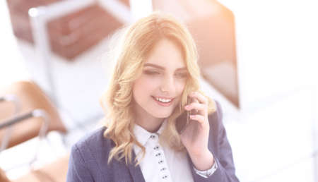 closeup.young employee talking on the phone