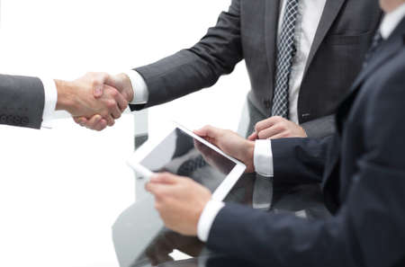 Two confident businessmen shaking hands during a meeting in theの写真素材