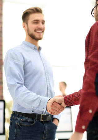 Portrait of two business partners shaking hands.の写真素材