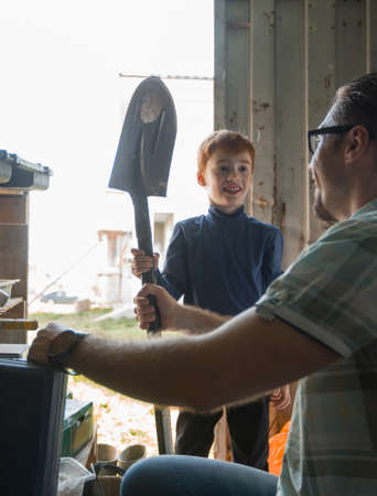 close up. happy father his little son is holding a shovel