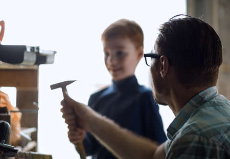 close up.the father and his little son are in the home garageの写真素材