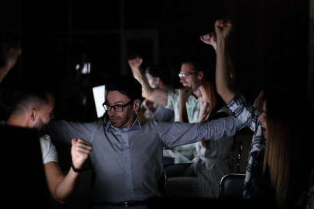 triumphant business team at the Desk